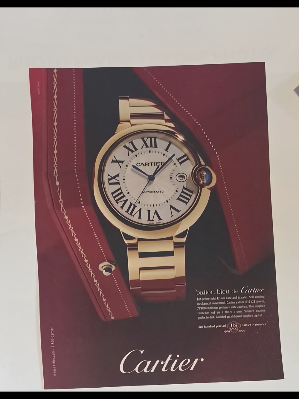 Cartier Gold Watch on Burgundy Background